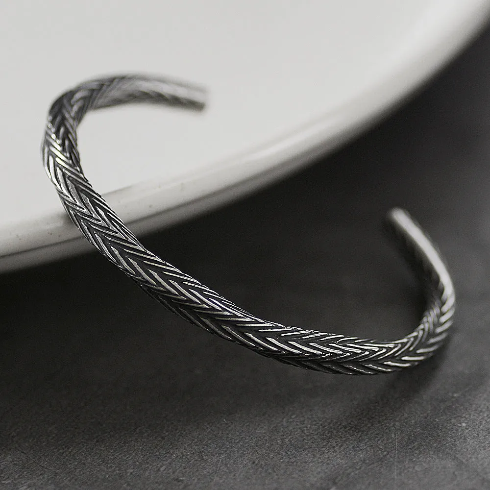 Men's white titanium steel pattern bracelet with geometric design on plain background