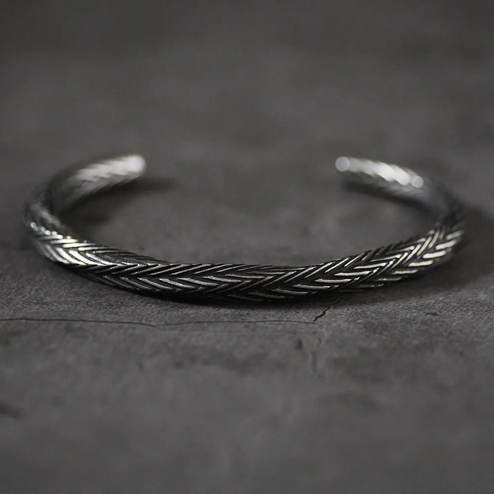 Men's white titanium steel pattern bracelet with geometric design on plain background