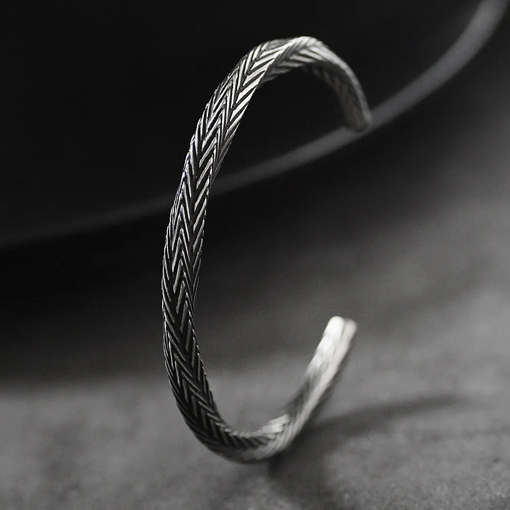 Men's white titanium steel pattern bracelet with geometric design on plain background