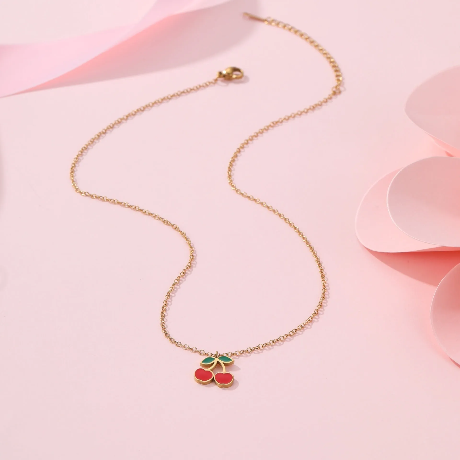 Complete cherry jewellery set with stainless steel necklace, bracelet, earrings, and ring on 18K electroplated chain.