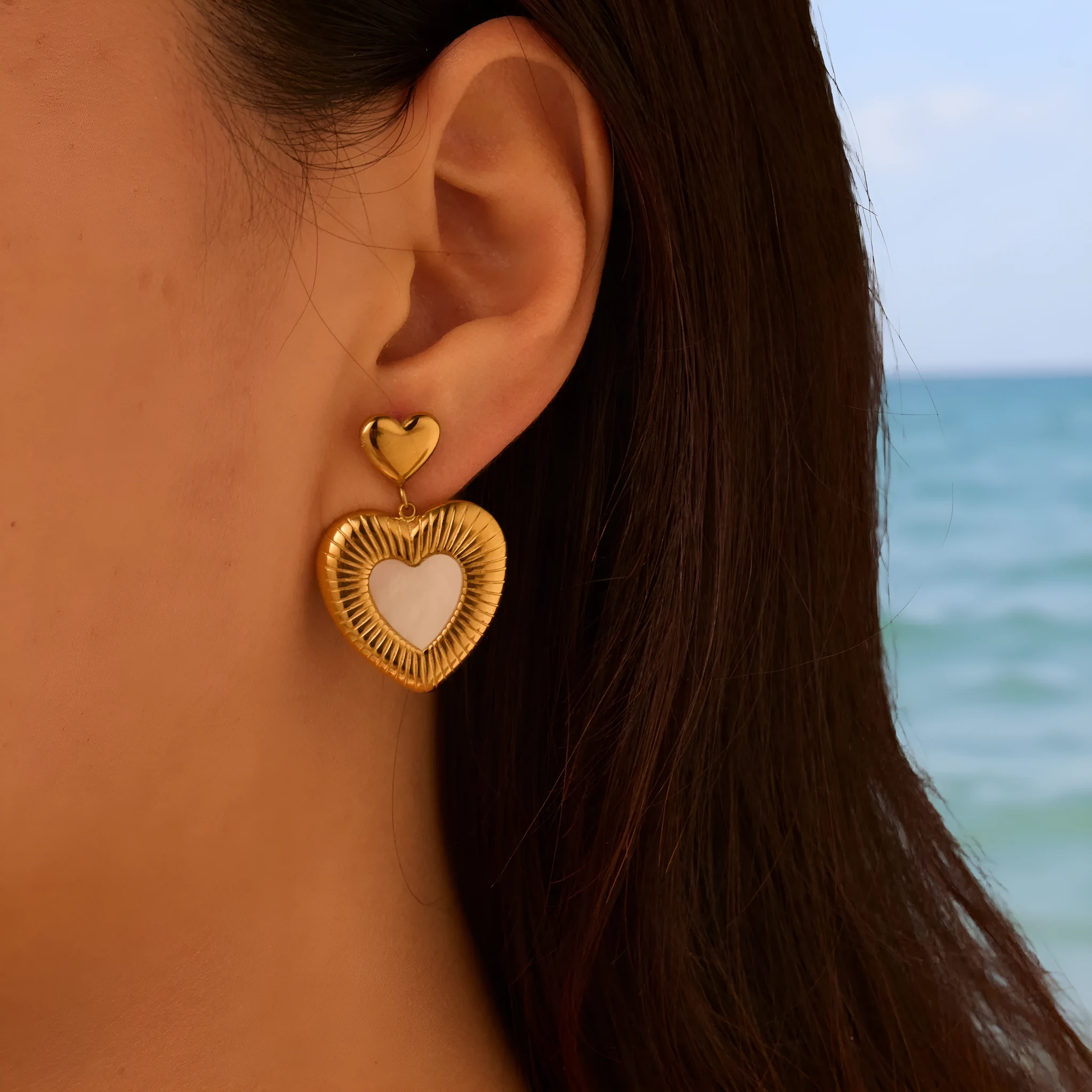 A pair of gold heart-shaped white fritillary earrings for women, made from stainless steel with 18K electroplating.