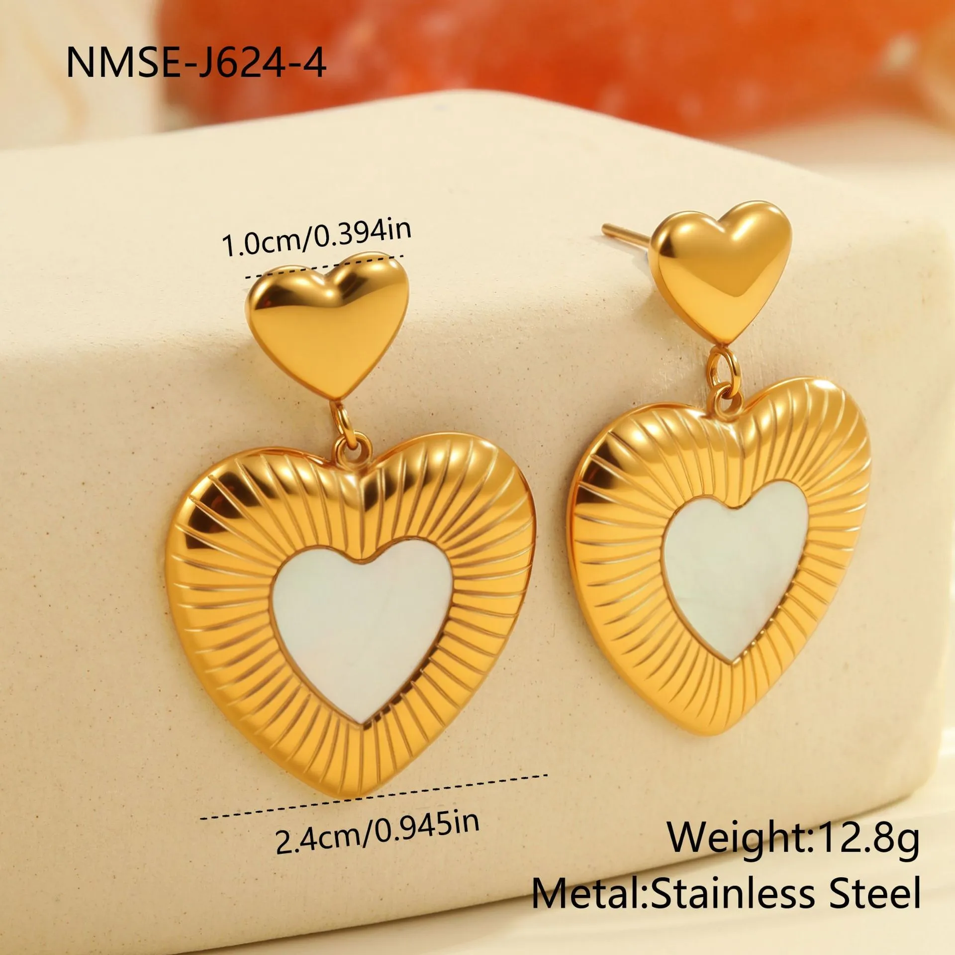 A pair of gold heart-shaped white fritillary earrings for women, made from stainless steel with 18K electroplating.
