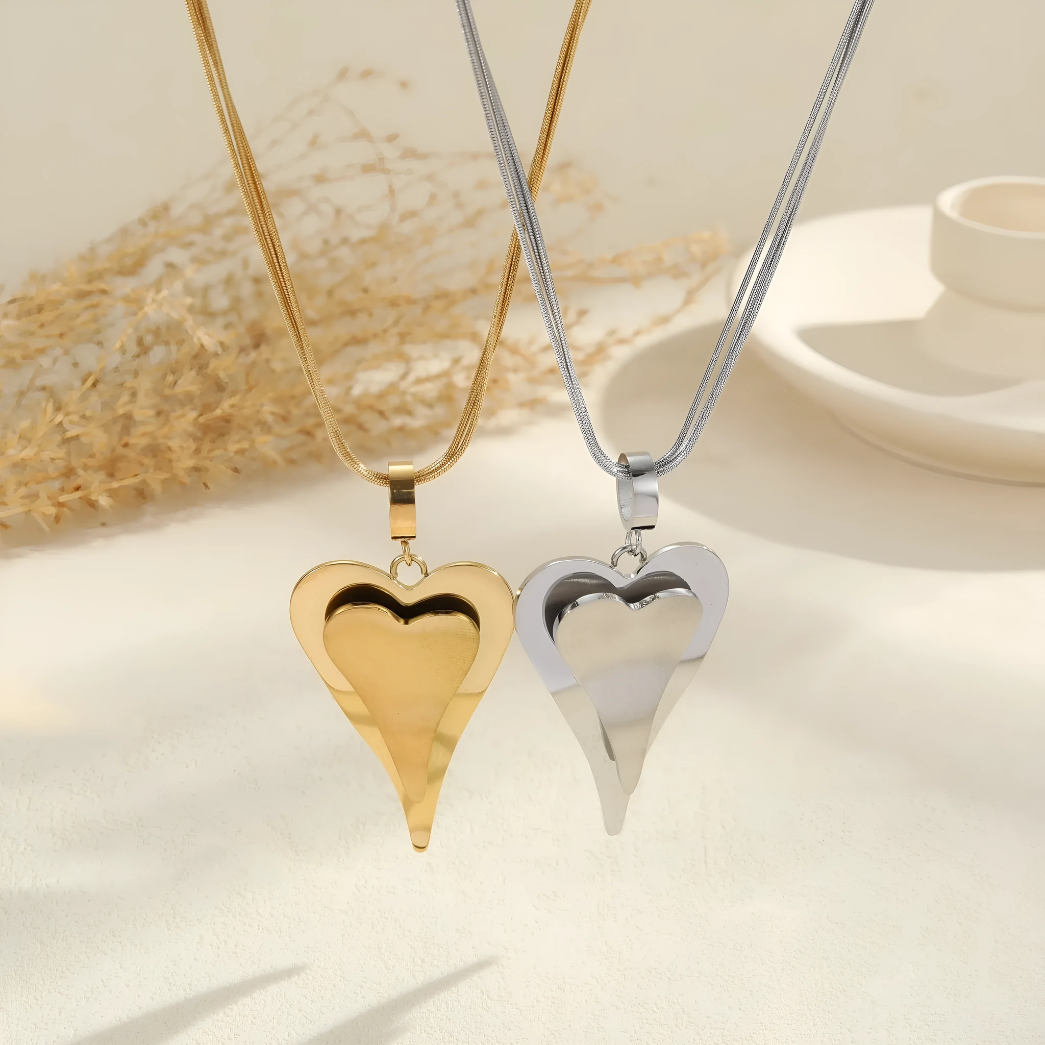 Stainless steel women's necklace with geometric double heart pendant on snake bones chain