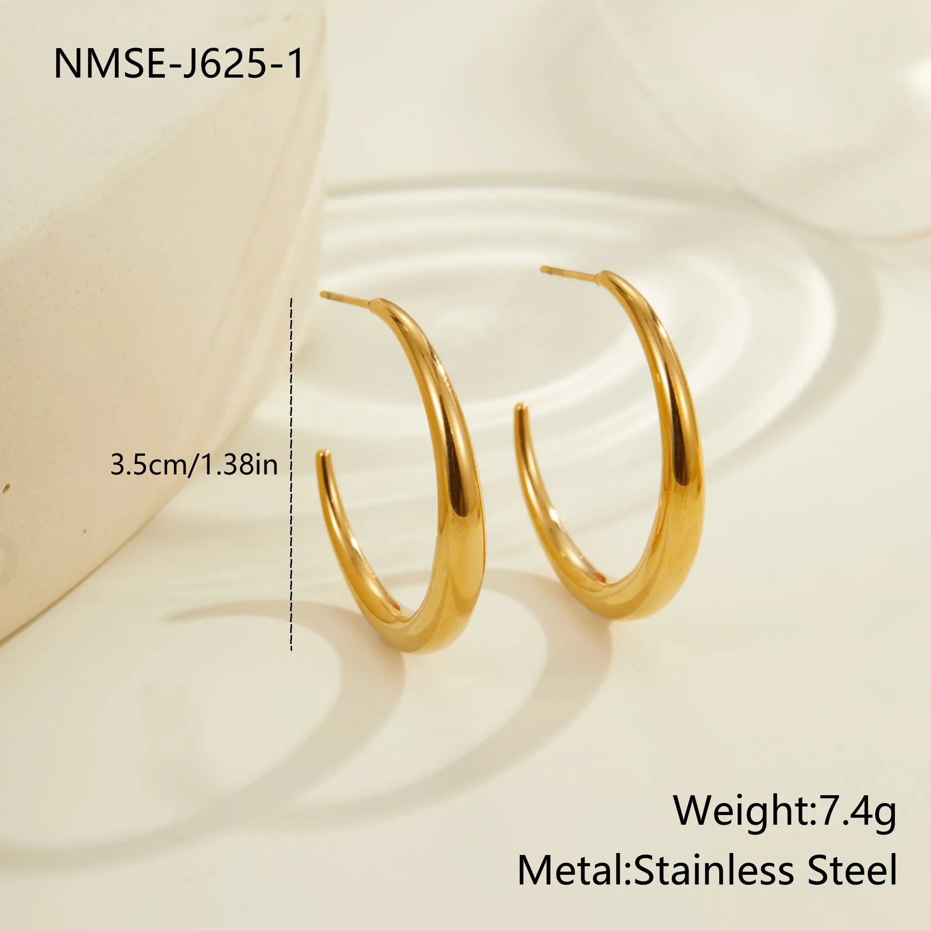 A pair of round titanium steel hoop earrings with an 18K gold plated finish, shown in large and small size options.