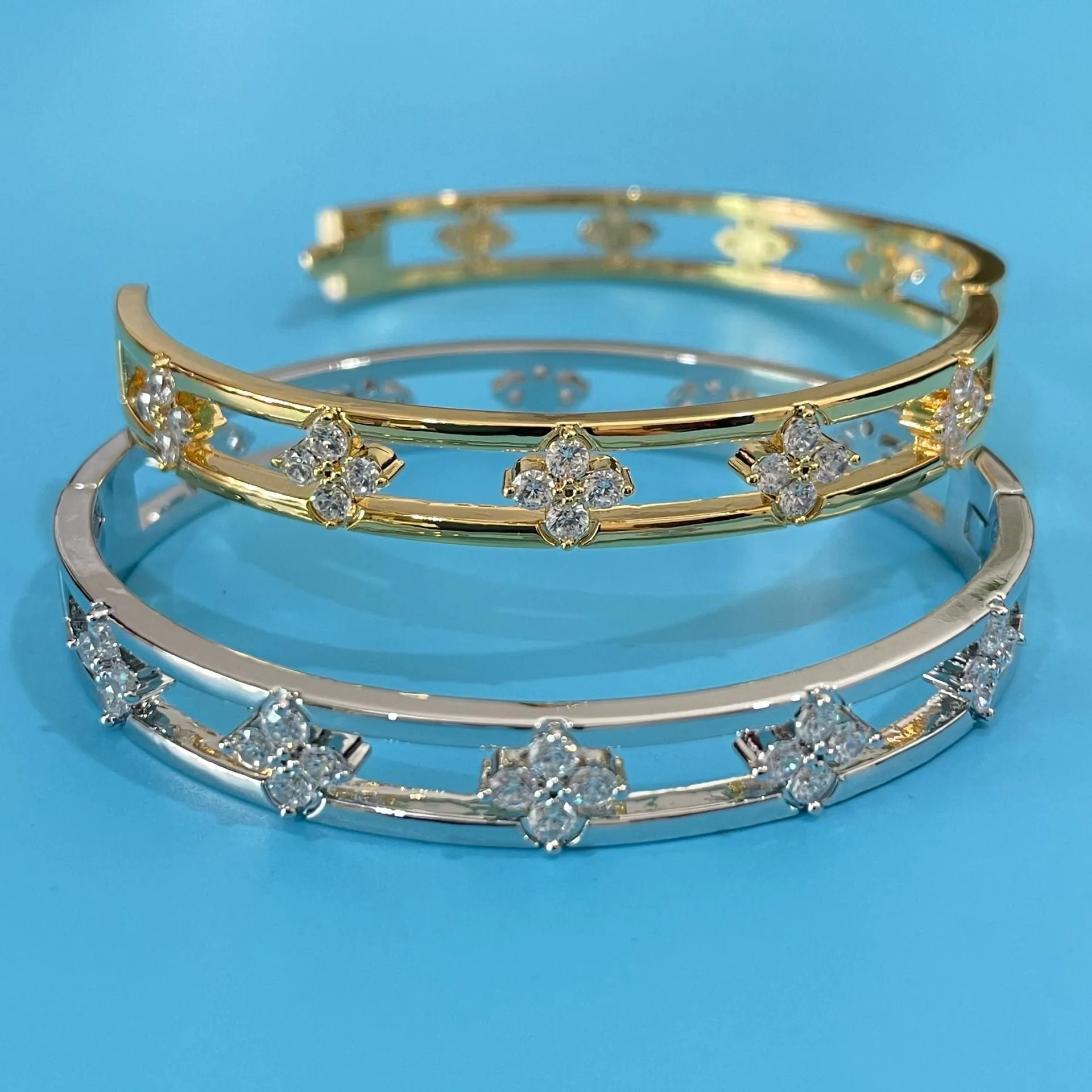Hollow women's bracelet with four-leaf clover charm containing inlaid AAA zircon gemstones