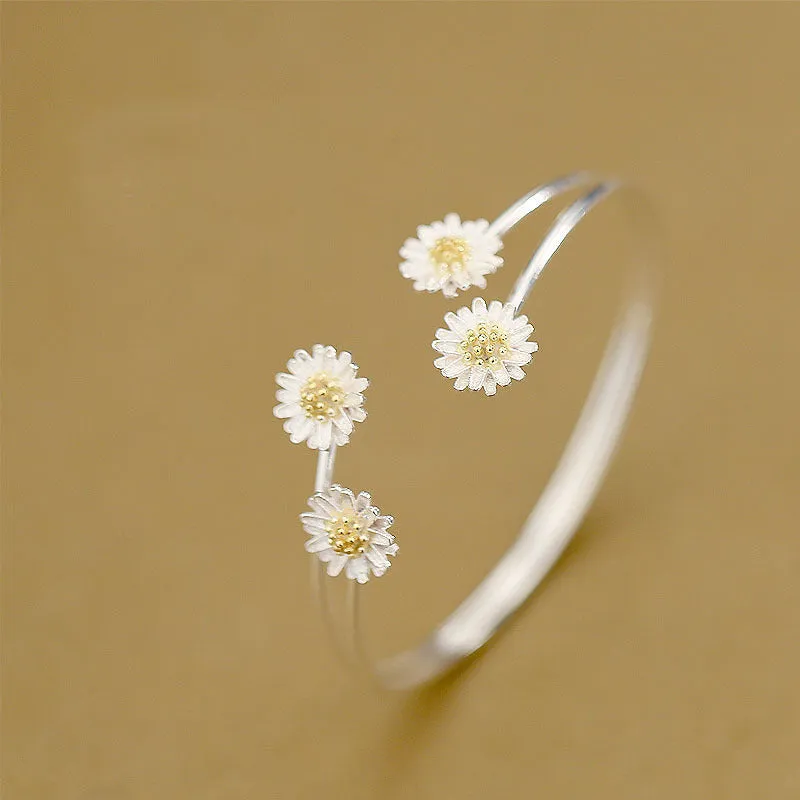 S925 sterling silver double daisy bracelet on a plain background, showing two daisy-shaped elements in a layered design