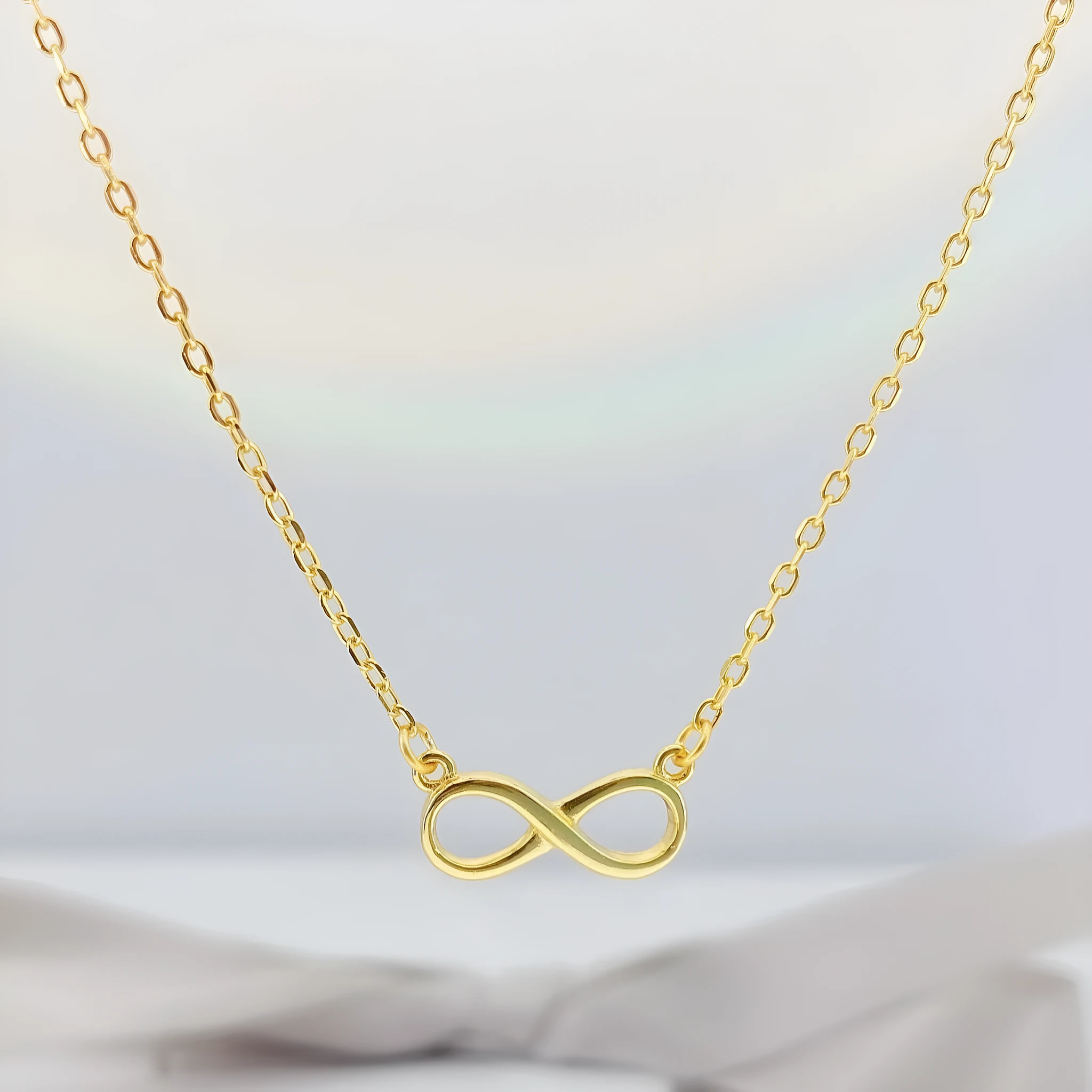 925 silver through-the-body pendant necklace with adjustable chain in platinum finish on collarbone