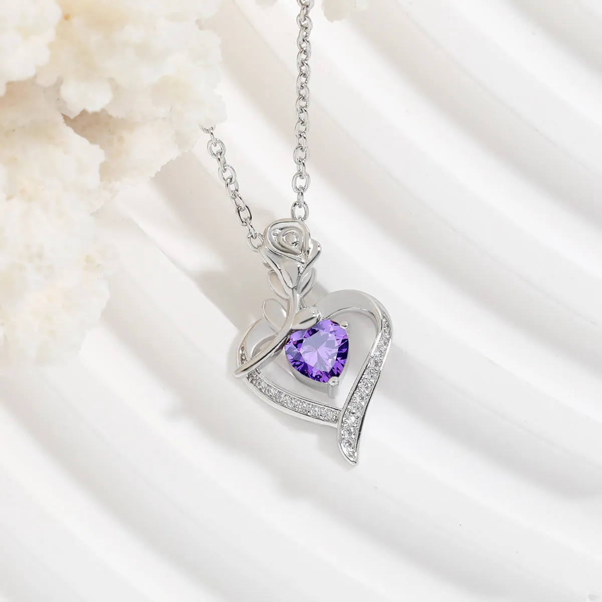 Rose heart-shaped necklace with rhinestones in copper electroplated finish, available in blue, purple, red, or white