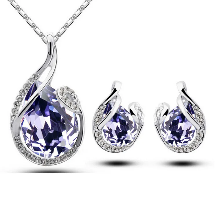 Rhinestone earring and necklace set in white with alloy inlaid gemstones on a display background