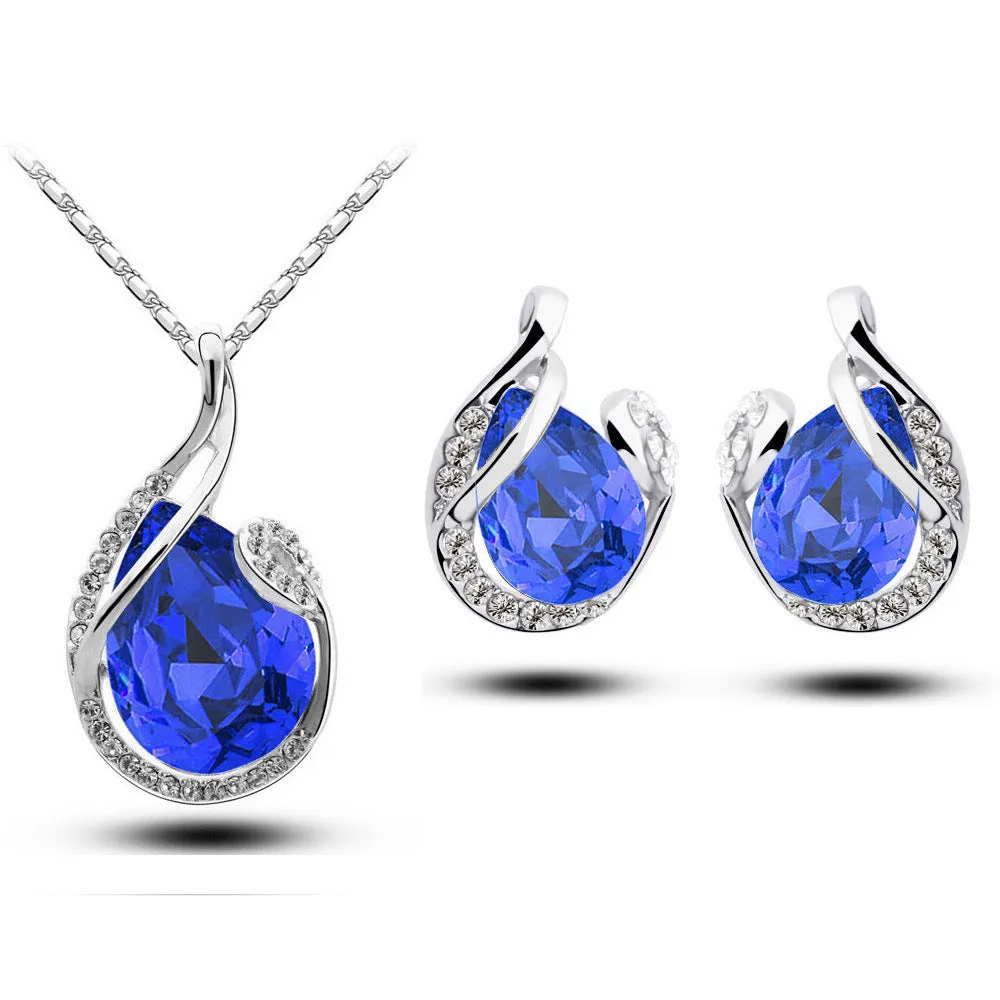 Rhinestone earring and necklace set in white with alloy inlaid gemstones on a display background