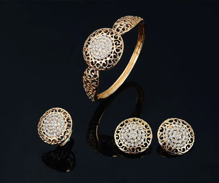Gold jewellery four piece set with necklace, earrings, ring, and hand accessories featuring alloy and artificial gems