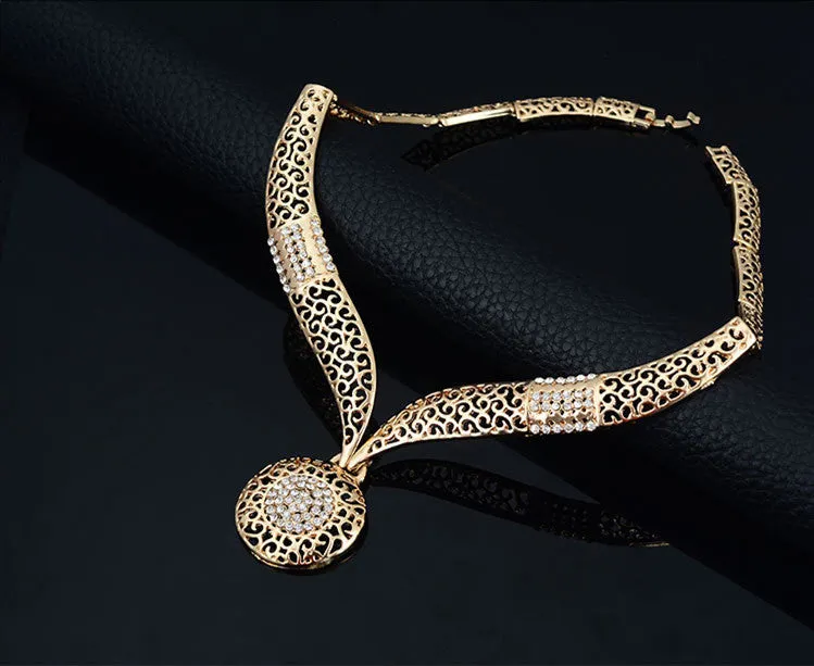 Gold jewellery four piece set with necklace, earrings, ring, and hand accessories featuring alloy and artificial gems