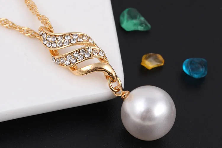 Pearl stud necklace set with mother-of-pearl pendant on water wave chain in gold finish