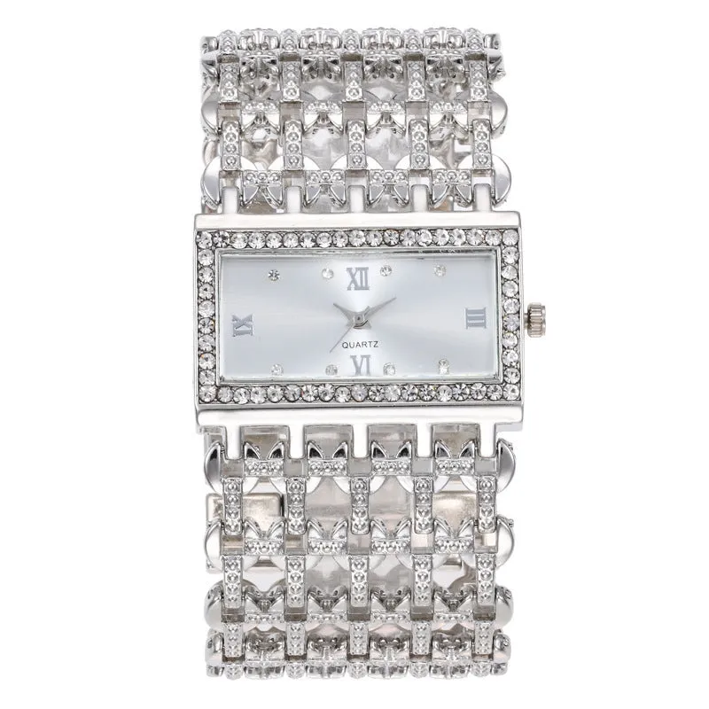 Women's steel band watch with square dial, Roman numerals, rhinestone details, and spiral crown in gold finish