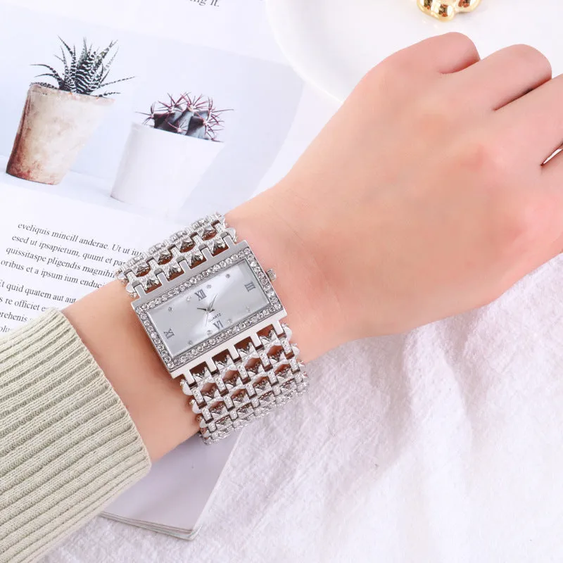 Women's steel band watch with square dial, Roman numerals, rhinestone details, and spiral crown in gold finish