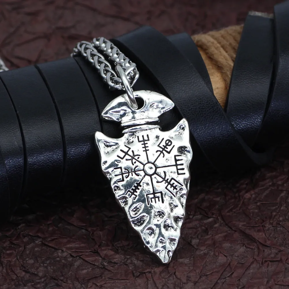 Alloy compass pendant necklace with twisted chain on a flat surface showing silver finish