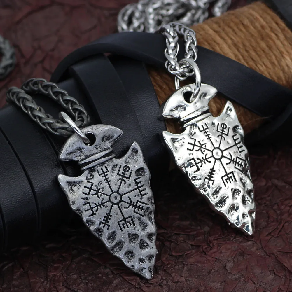 Alloy compass pendant necklace with twisted chain on a flat surface showing silver finish