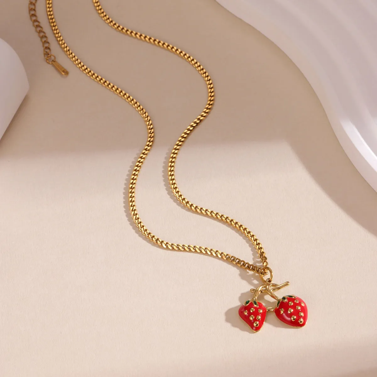 Stainless steel strawberry pendant necklace on an alloy chain, shown in red and white gradient colour options.