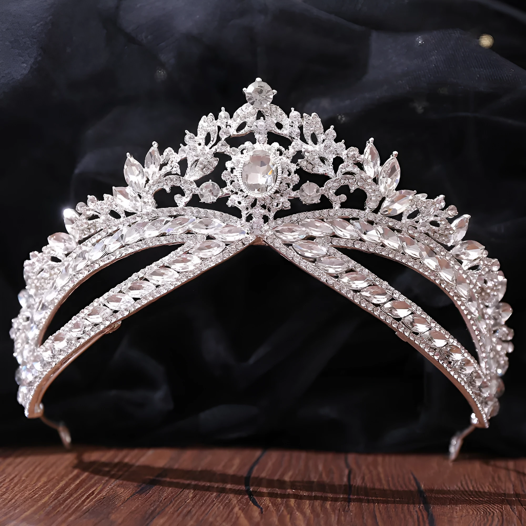 Wedding crown headdress with rhinestone and crystal in silver white finish on display