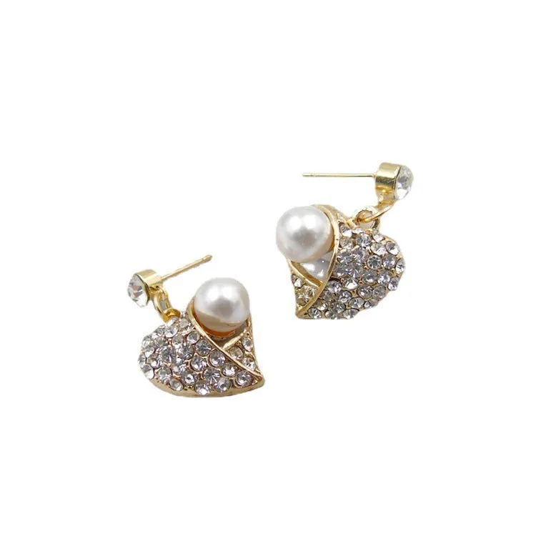 Gold heart pearl jewellery set with alloy necklace and earrings on display