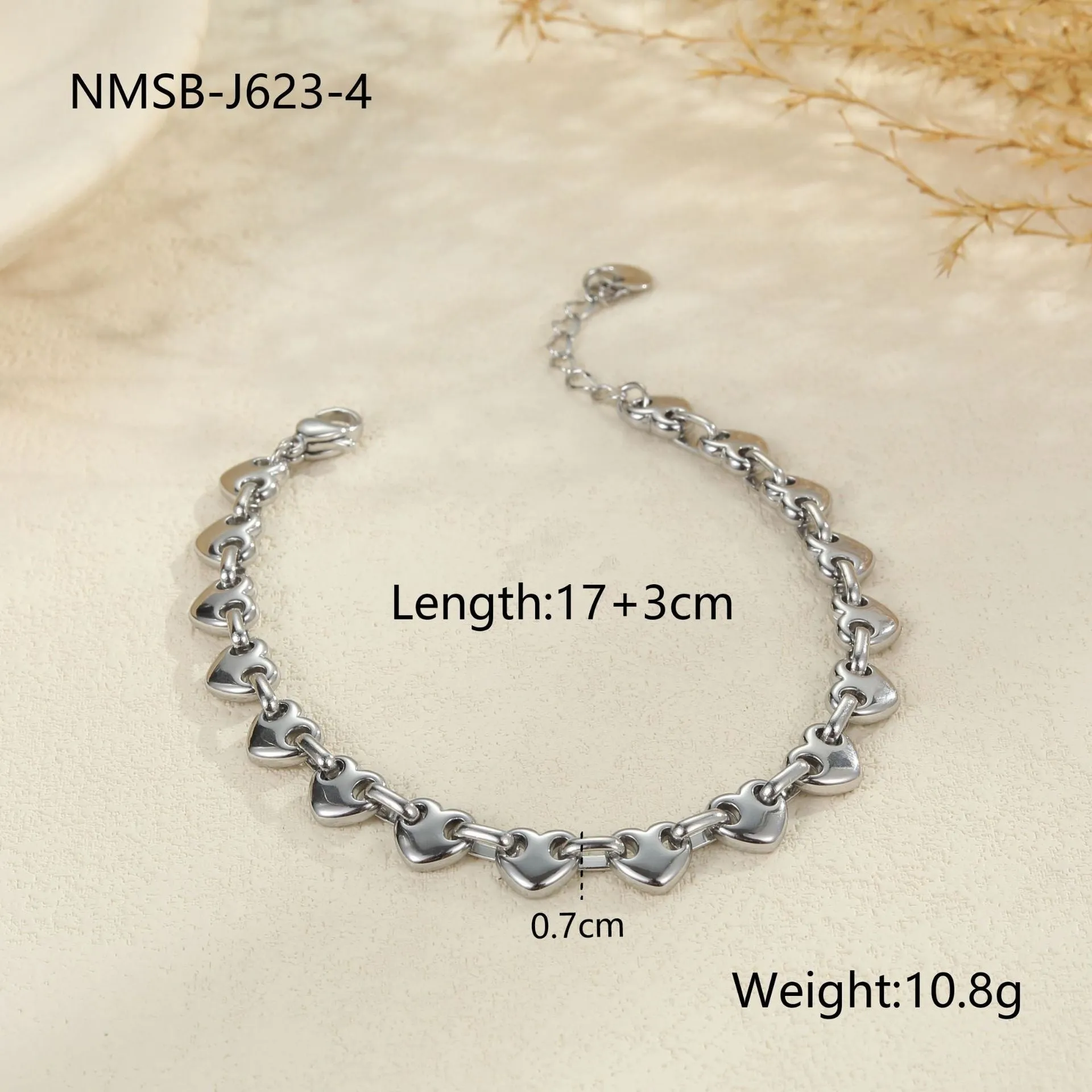 Stainless steel women's bracelet with a hollowed-out heart design in gold, steel, or colour-blocked finish.