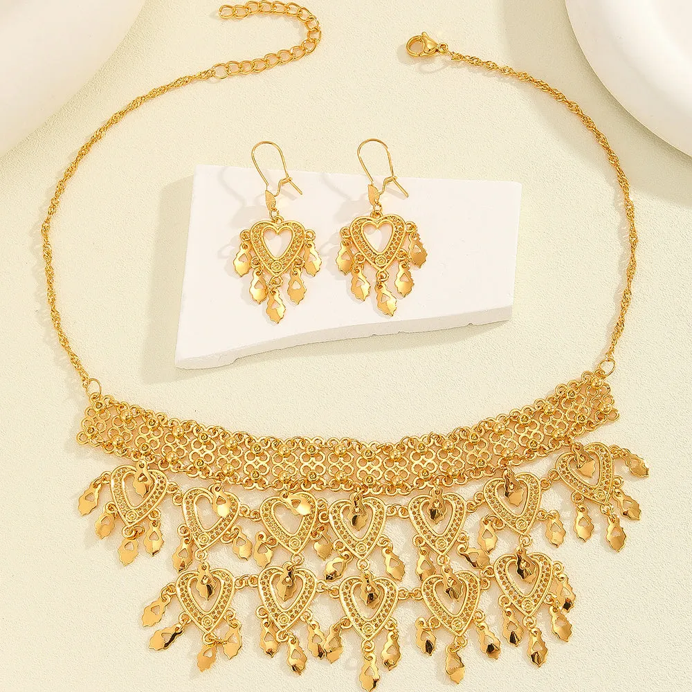 Gold alloy heart-shaped hollow necklace and matching earrings set on display with multiple hanging leaf ornaments