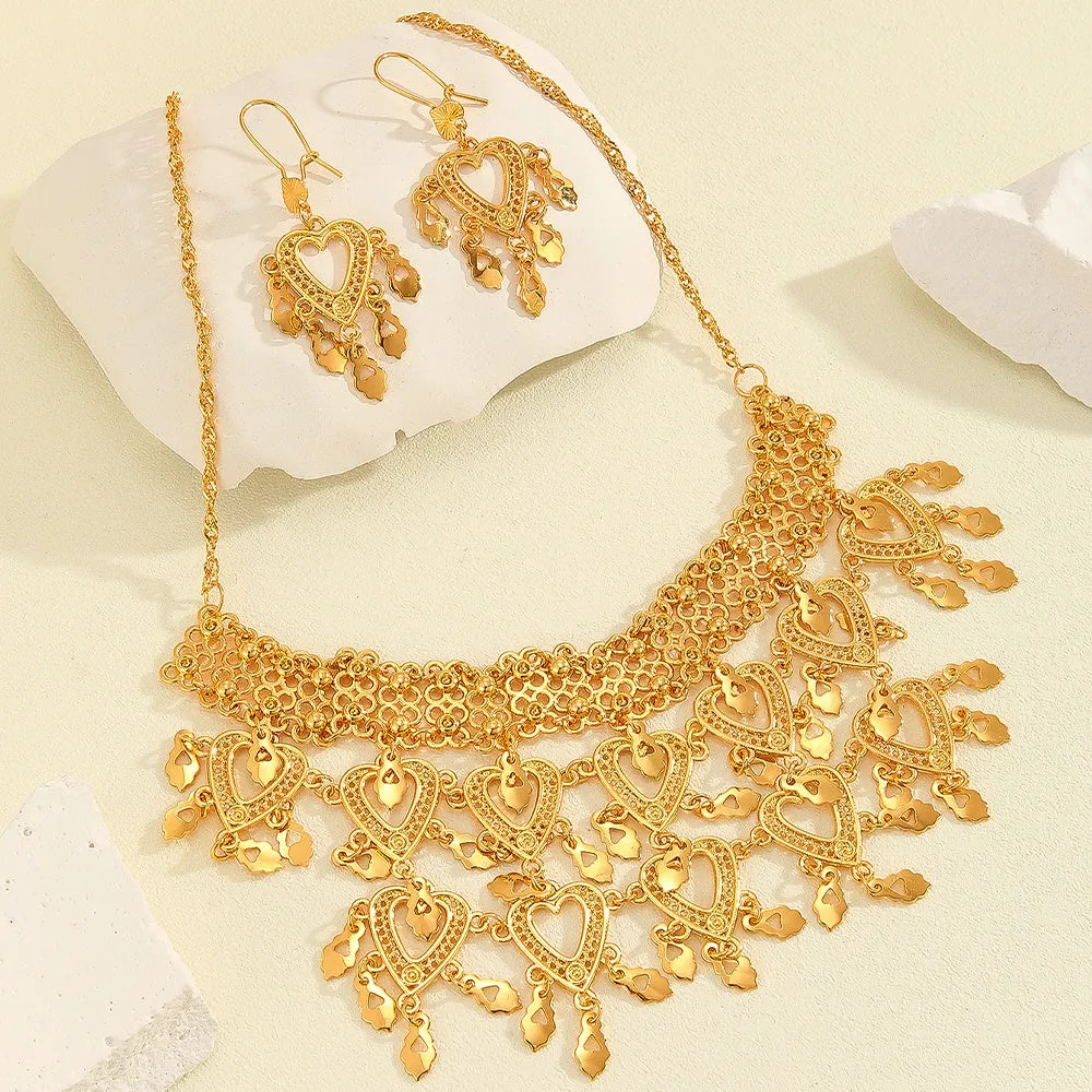 Gold alloy heart-shaped hollow necklace and matching earrings set on display with multiple hanging leaf ornaments