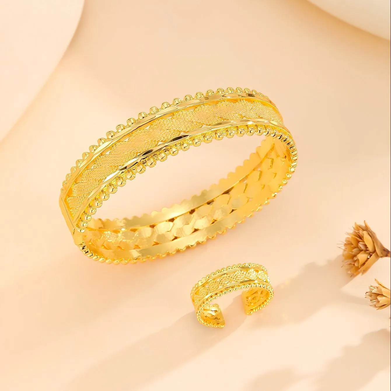 2pcs vintage gold plated bracelet and ring set with floral design and bead edges on a white background
