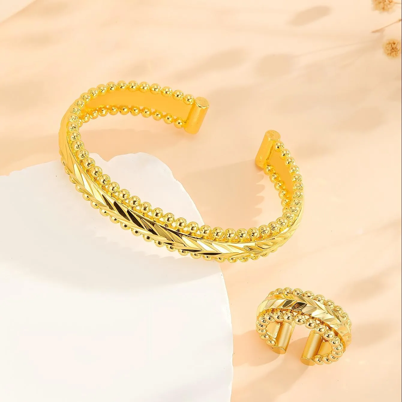 2pcs vintage gold plated bracelet and ring set with floral design and bead edges on a white background