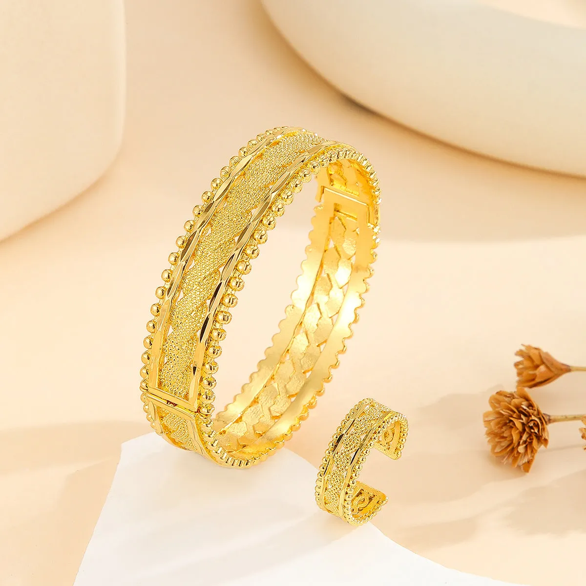 2pcs vintage gold plated bracelet and ring set with floral design and bead edges on a white background