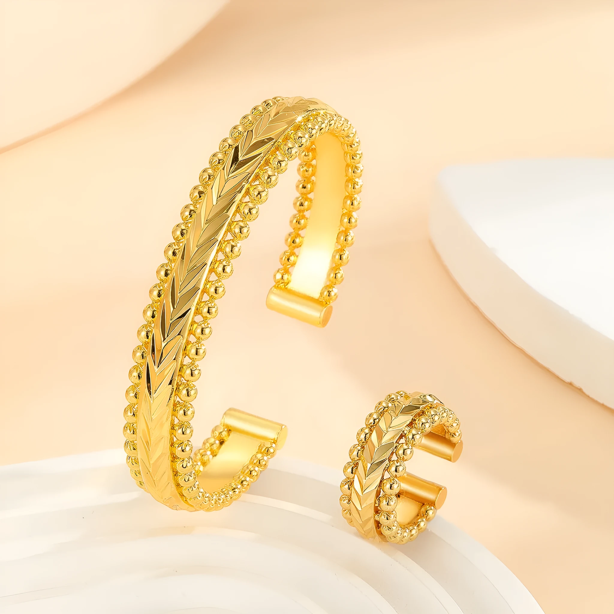 2pcs vintage gold plated bracelet and ring set with floral design and bead edges on a white background