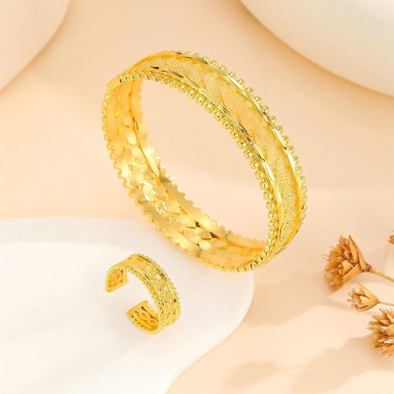 2pcs vintage gold plated bracelet and ring set with floral design and bead edges on a white background