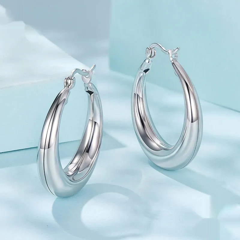 A pair of copper geometric ring ear clips with a silver needle, shown in large, medium, and small sizes.