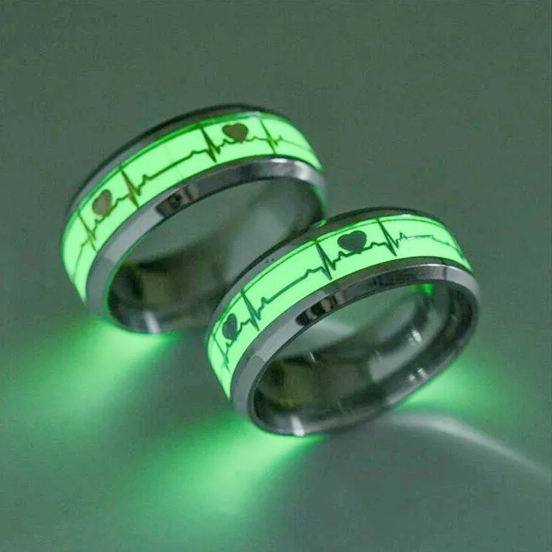 Gold heart-shaped stainless steel lovers ring with luminous glow, on white background