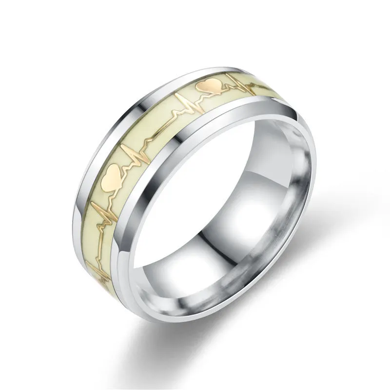 Gold heart-shaped stainless steel lovers ring with luminous glow, on white background