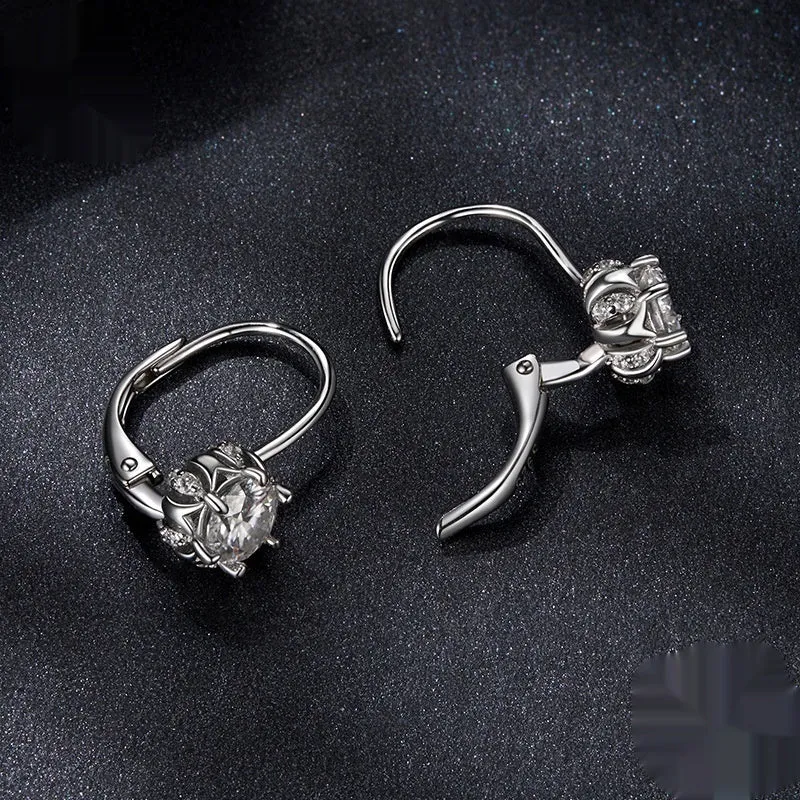 Sterling silver flower bud ear clips with white gold plating and a moissanite centre stone.