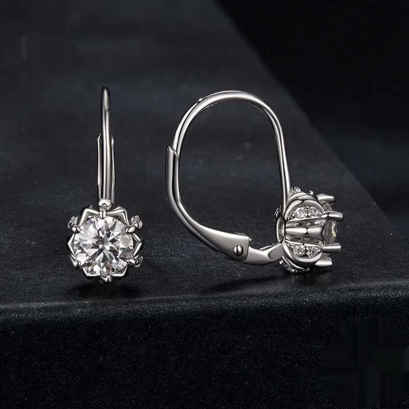 Sterling silver flower bud ear clips with white gold plating and a moissanite centre stone.