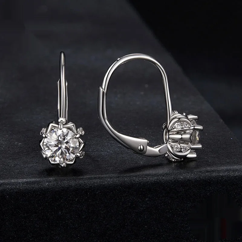 Sterling silver flower bud ear clips with white gold plating and a moissanite centre stone.