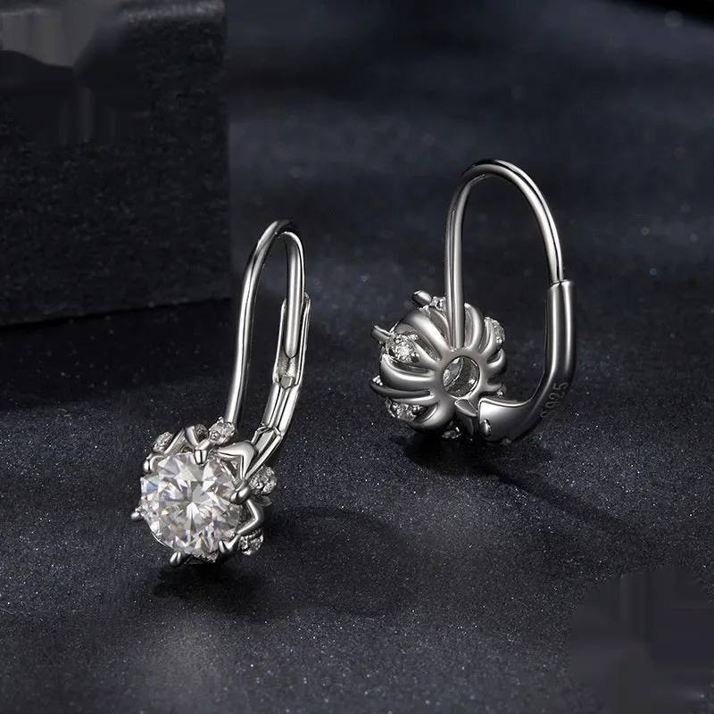 Sterling silver flower bud ear clips with white gold plating and a moissanite centre stone.