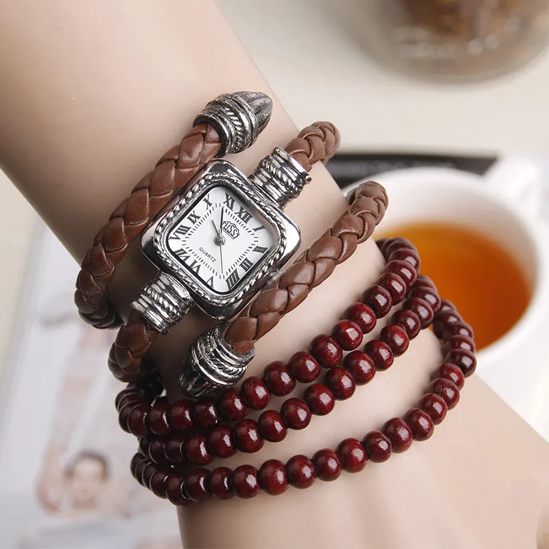 Snake bracelet quartz watch with leather strap and alloy buckle on a black background