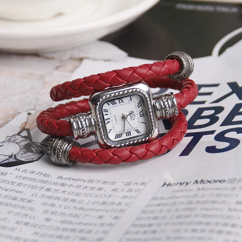 Snake bracelet quartz watch with leather strap and alloy buckle on a black background