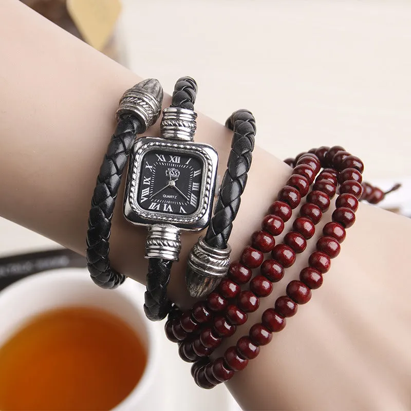 Snake bracelet quartz watch with leather strap and alloy buckle on a black background