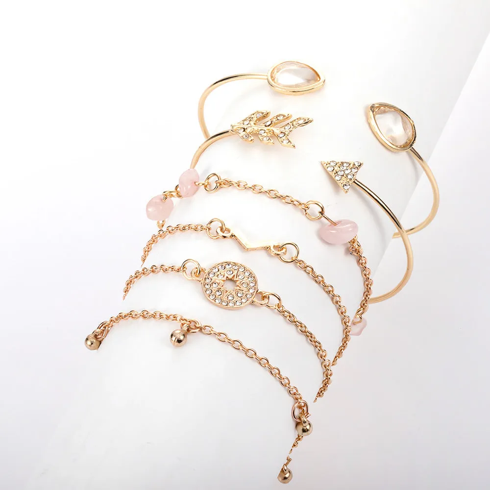 Gold zinc alloy bracelet set with water droplet and V-shaped designs for women.