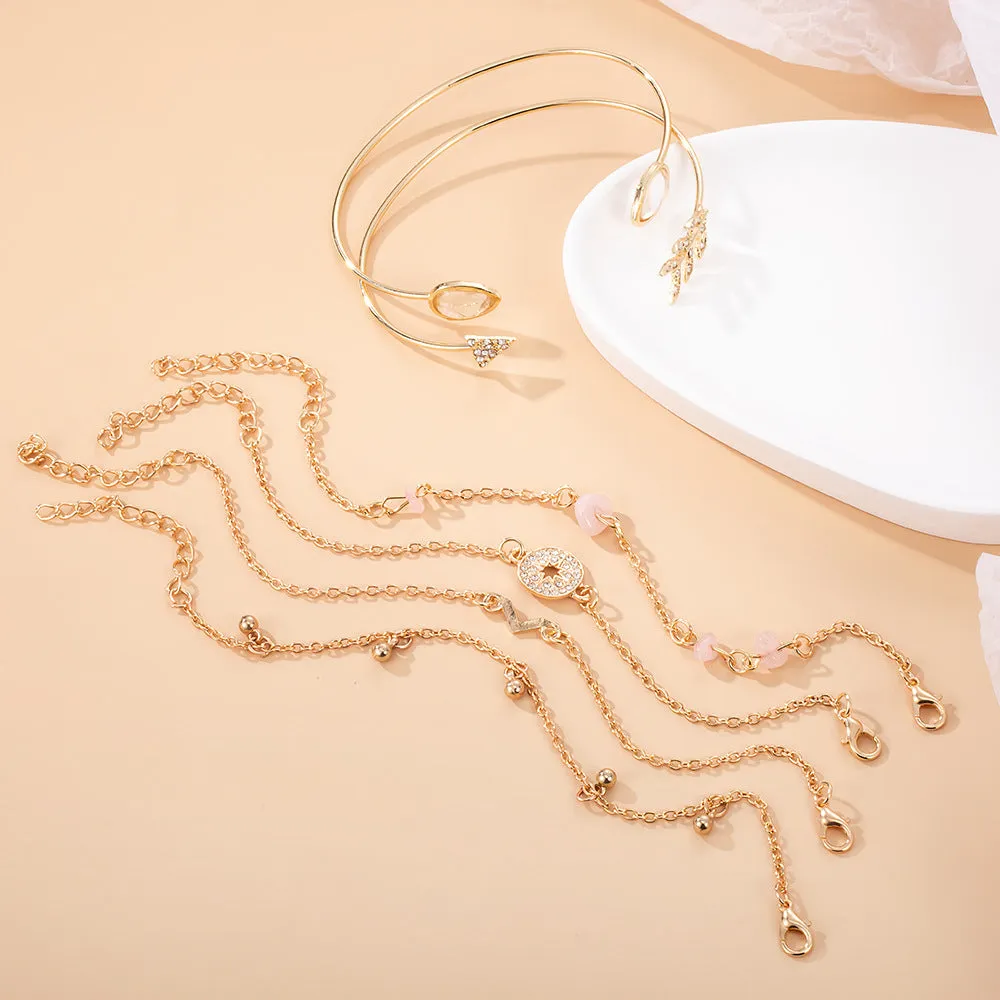 Gold zinc alloy bracelet set with water droplet and V-shaped designs for women.