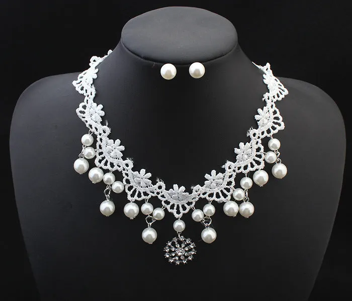 Three-piece white pearl jewellery set with necklace, earrings, and bracelet on display