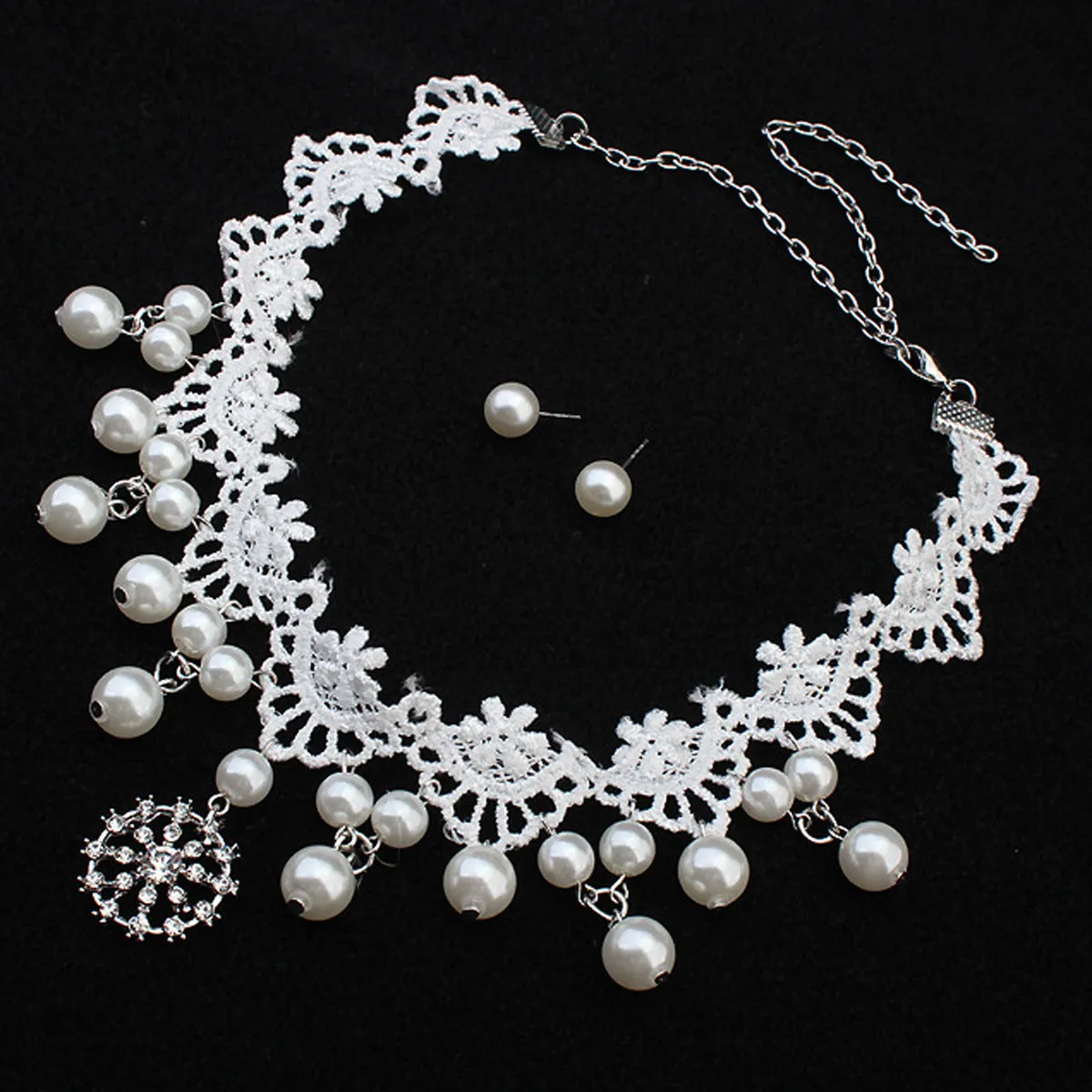 Three-piece white pearl jewellery set with necklace, earrings, and bracelet on display