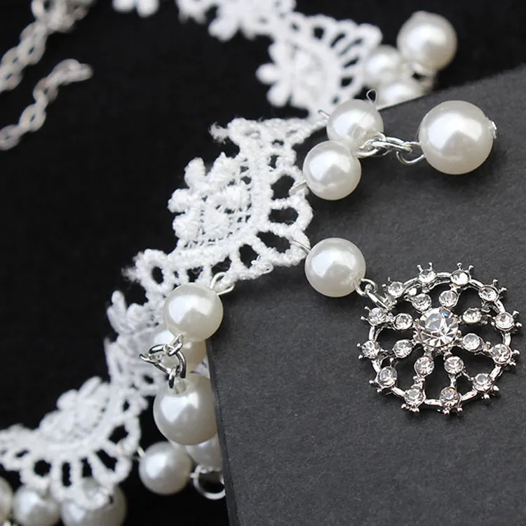 Three-piece white pearl jewellery set with necklace, earrings, and bracelet on display
