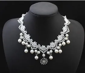 Three-piece white pearl jewellery set with necklace, earrings, and bracelet on display
