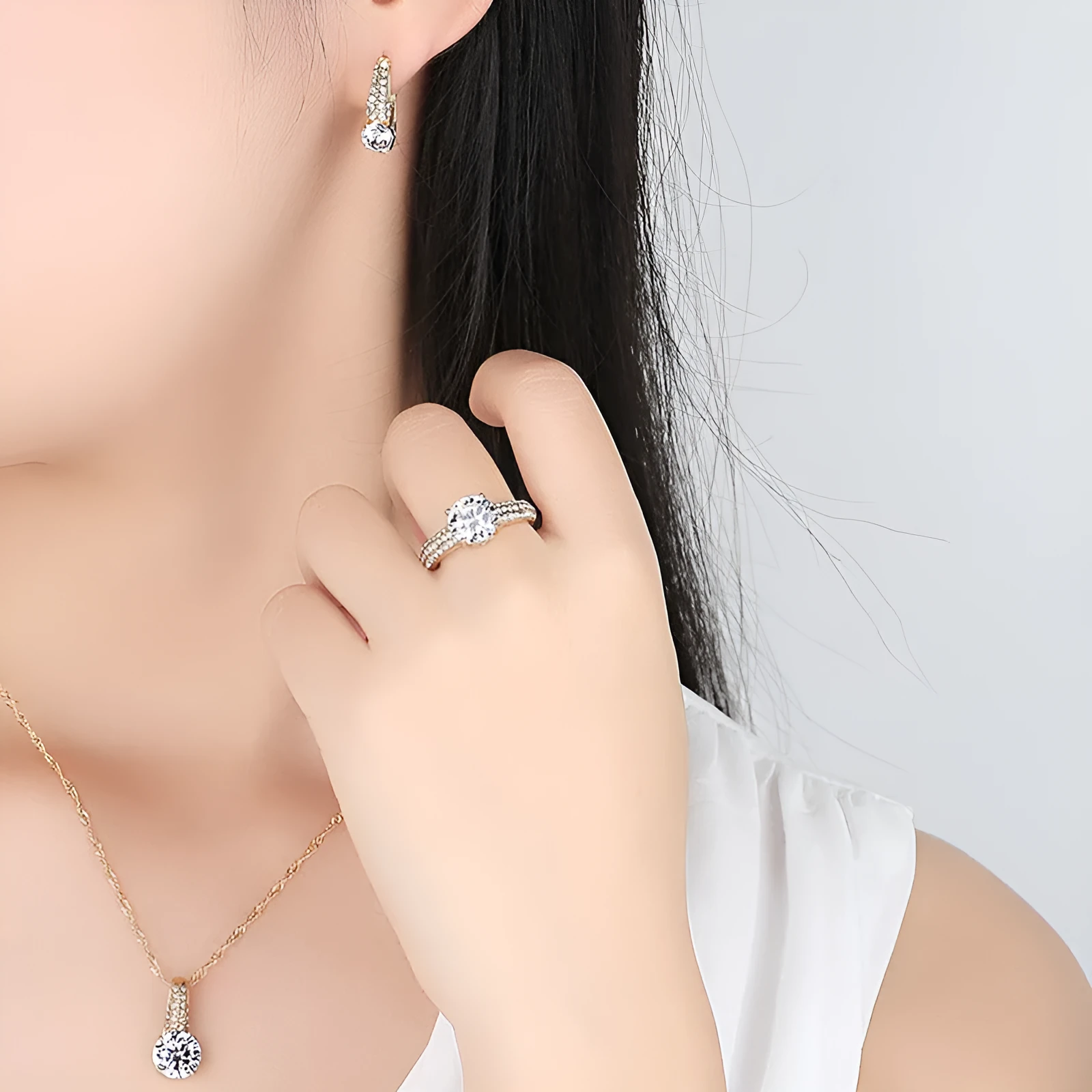Gold and silver bridal necklace and earring set with copper base platinum finish on display