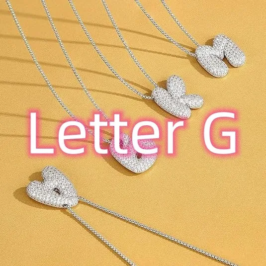 Brass zircon balloon English letter necklace in gold finish, copper base with inlaid zircon stones, on a woman's collarbone